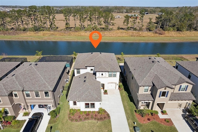 birds eye view of property with a residential view and a water view