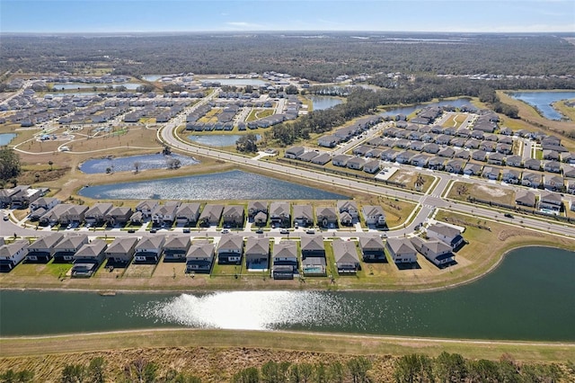 drone / aerial view featuring a residential view and a water view