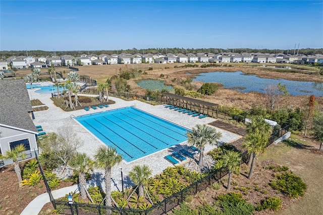 pool with a residential view, a patio area, and fence