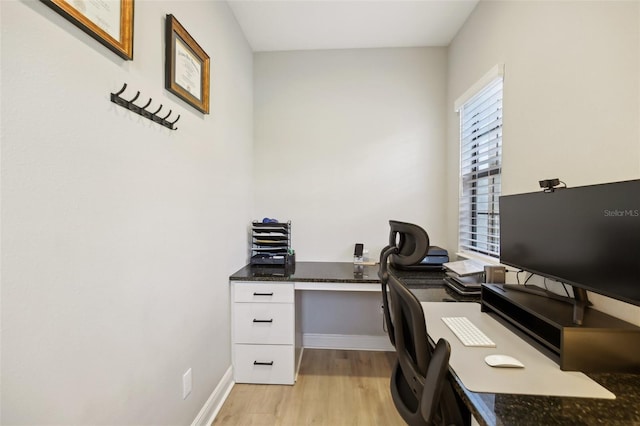 home office featuring light wood finished floors and baseboards