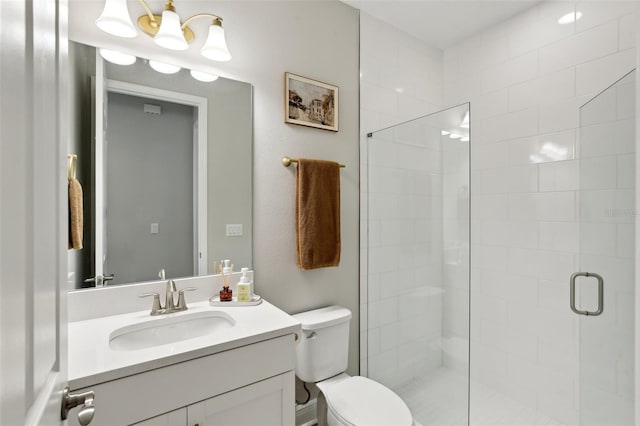 bathroom featuring a stall shower, vanity, and toilet