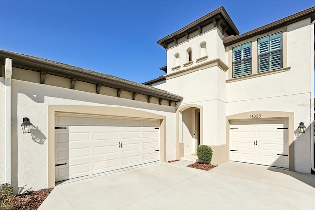 view of front of house with driveway and stucco siding