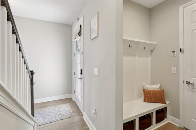 mudroom featuring light wood-style flooring and baseboards