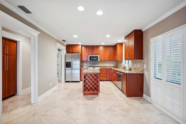 kitchen with sink, light stone countertops, a center island, ornamental molding, and stainless steel appliances