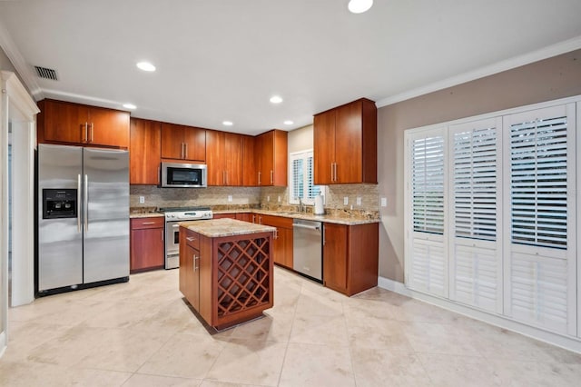 kitchen featuring a center island, crown molding, backsplash, stainless steel appliances, and light tile patterned flooring