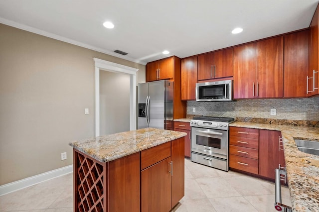 kitchen featuring light tile patterned floors, light stone counters, crown molding, and appliances with stainless steel finishes