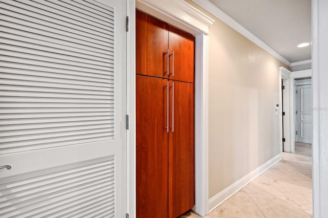 hall with light tile patterned floors and ornamental molding