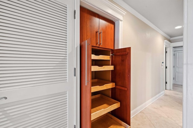 hallway featuring crown molding and light tile patterned floors