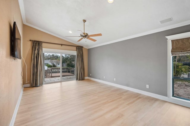 spare room with crown molding, light wood-type flooring, and lofted ceiling