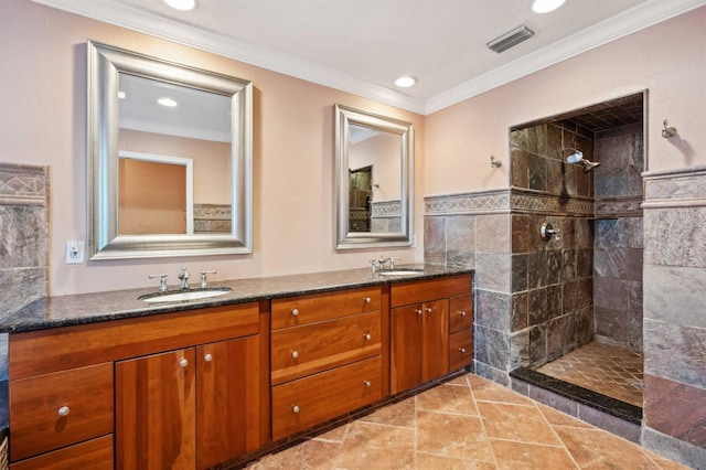 bathroom featuring vanity, ornamental molding, and a tile shower