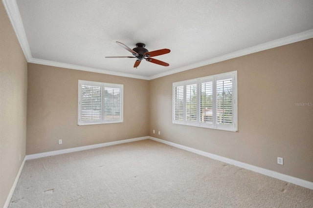 unfurnished room featuring plenty of natural light, light colored carpet, and ornamental molding