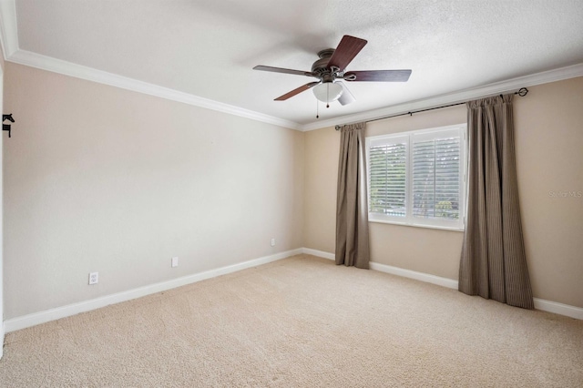 empty room featuring ceiling fan, crown molding, light carpet, and a textured ceiling