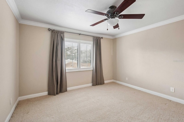 carpeted empty room featuring ceiling fan and ornamental molding