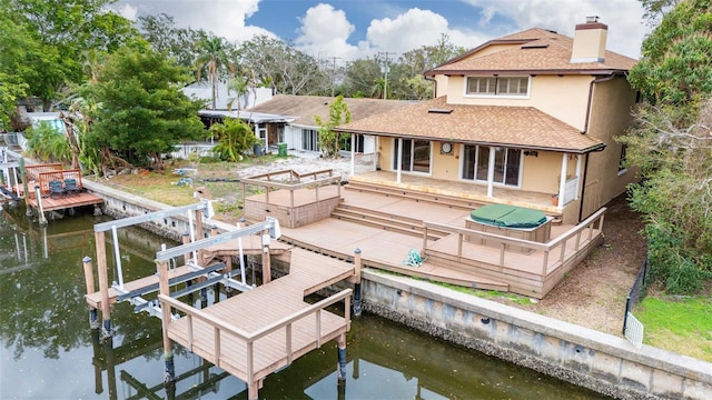 rear view of property featuring a patio and a water view