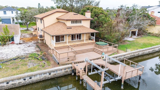 back of house featuring a deck with water view