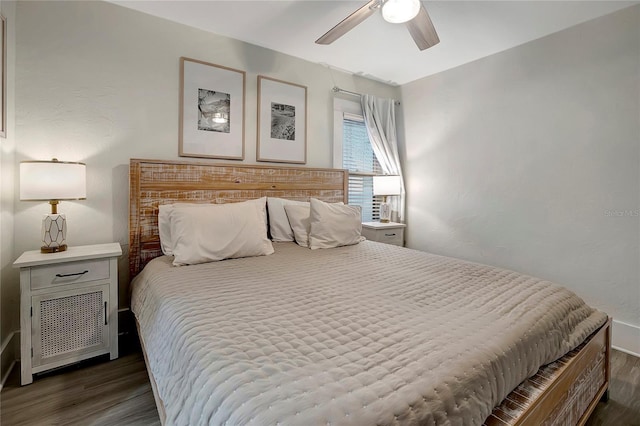 bedroom with ceiling fan and dark wood finished floors