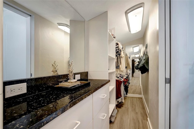 bathroom with vanity and wood finished floors