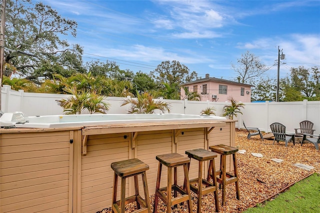 exterior space with outdoor dry bar and a fenced backyard