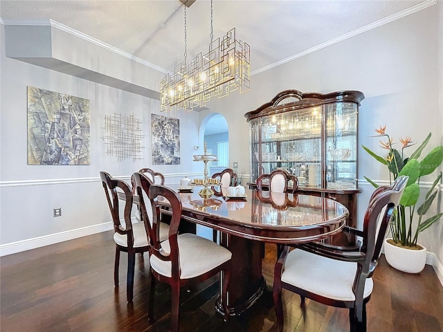 dining room with ornamental molding and dark hardwood / wood-style flooring