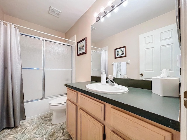 full bathroom with vanity, shower / bath combination with glass door, and toilet