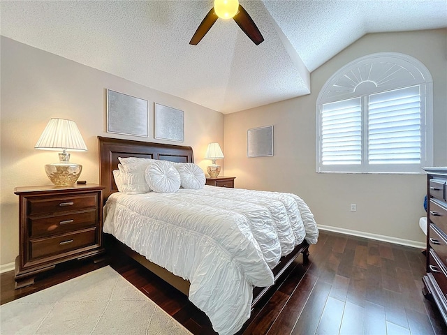 bedroom featuring dark wood-type flooring, ceiling fan, vaulted ceiling, and a textured ceiling