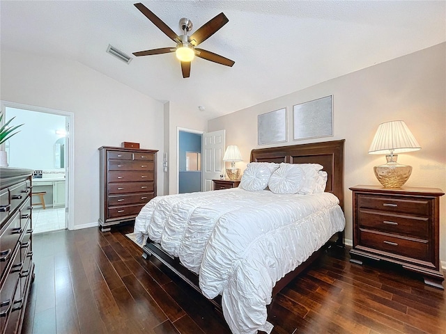 bedroom featuring dark wood-type flooring, ensuite bath, lofted ceiling, and ceiling fan