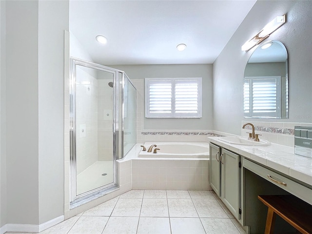 bathroom with a healthy amount of sunlight, tile patterned floors, shower with separate bathtub, and vanity