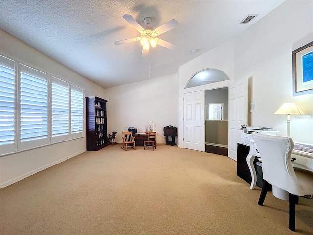 office area featuring ceiling fan, carpet flooring, and a textured ceiling