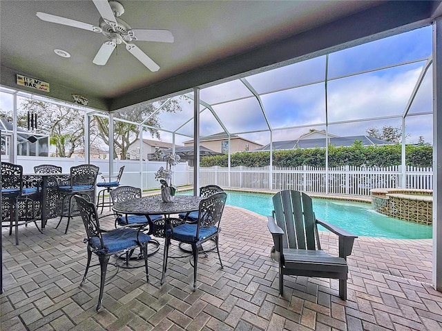 view of patio with ceiling fan, a lanai, and a pool with hot tub