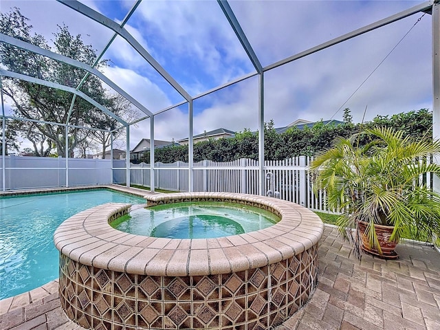 view of pool featuring an in ground hot tub, a lanai, and a patio area