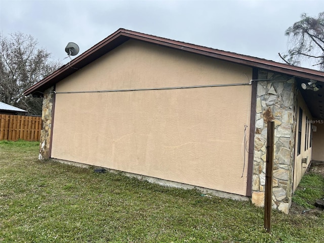 view of property exterior with a lawn