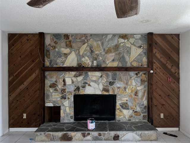 details featuring wood walls, a fireplace, and a textured ceiling