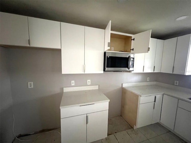 kitchen featuring white cabinetry and light tile patterned floors