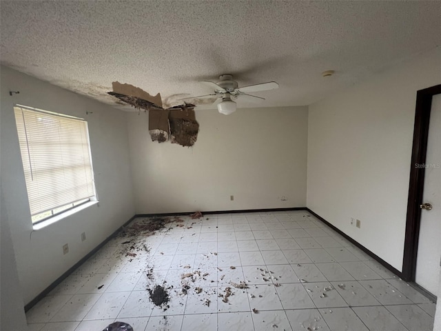 spare room with ceiling fan and a textured ceiling