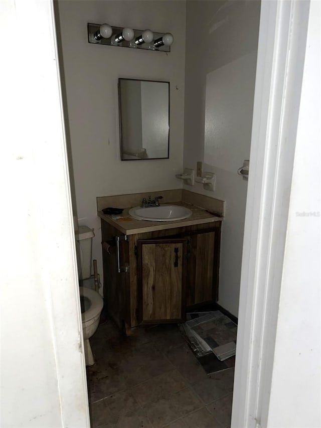 bathroom featuring toilet and vanity