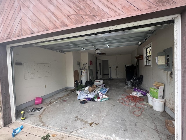 garage featuring a garage door opener, electric panel, and electric water heater