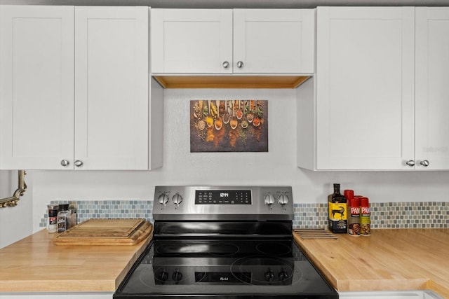 kitchen featuring white cabinetry, backsplash, and stainless steel range with electric cooktop