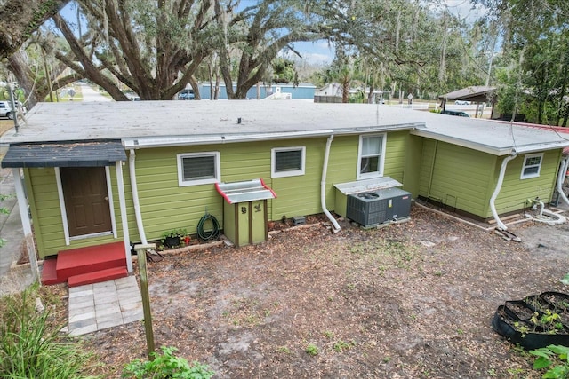 rear view of house featuring cooling unit