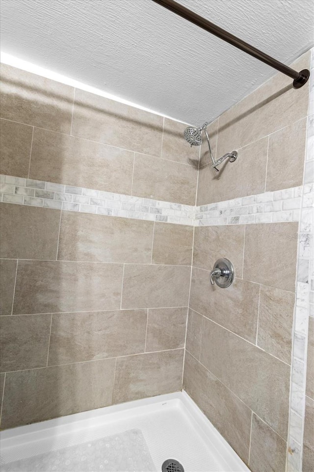 bathroom with tiled shower