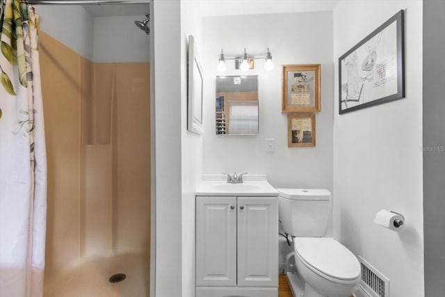 bathroom with toilet, vanity, and a shower with shower curtain