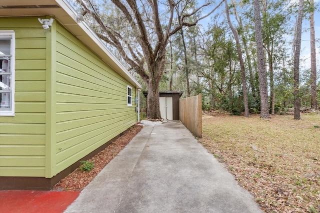 view of side of property featuring a storage unit