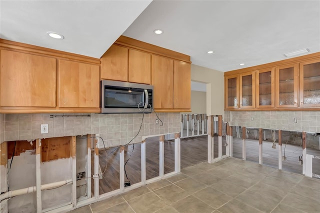 kitchen featuring tasteful backsplash and light tile patterned floors