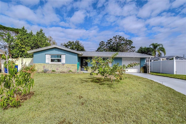 single story home with an attached garage, fence, stone siding, concrete driveway, and a front lawn