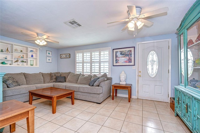 living area with visible vents, ceiling fan, plenty of natural light, and light tile patterned flooring