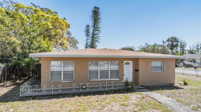 5130 Dr Martin Luther King Jr St S, Saint Petersburg, FL 33705 - view of front of home featuring stucco siding and fence
