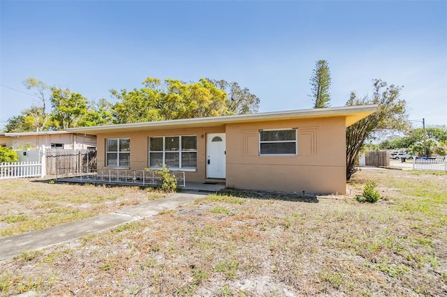 ranch-style home with fence