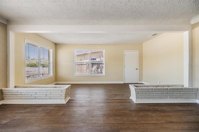 5130 Dr Martin Luther King Jr St S, Saint Petersburg, FL 33705 - unfurnished room with dark wood finished floors, visible vents, a textured ceiling, and baseboards
