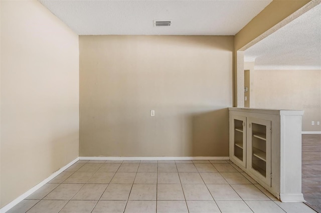 5130 Dr Martin Luther King Jr St S, Saint Petersburg, FL 33705 - unfurnished room with light tile patterned floors, visible vents, a textured ceiling, and baseboards