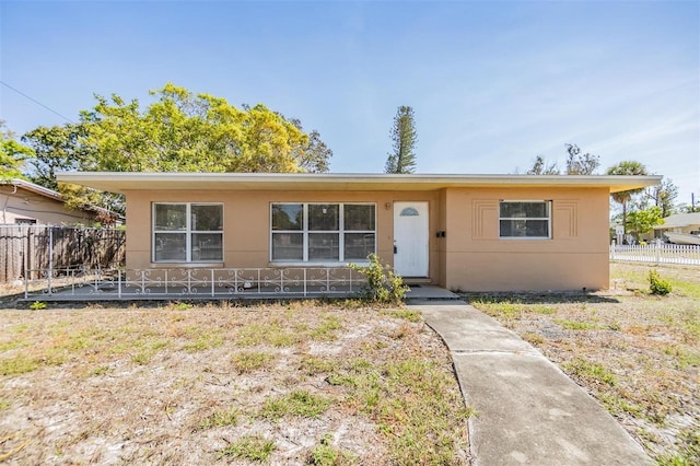 5130 Dr Martin Luther King Jr St S, Saint Petersburg, FL 33705 - view of front facade with stucco siding and fence