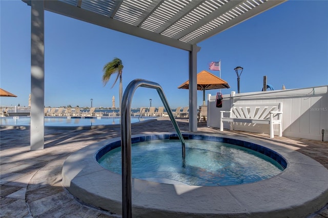 view of swimming pool with a hot tub, a water view, and a pergola